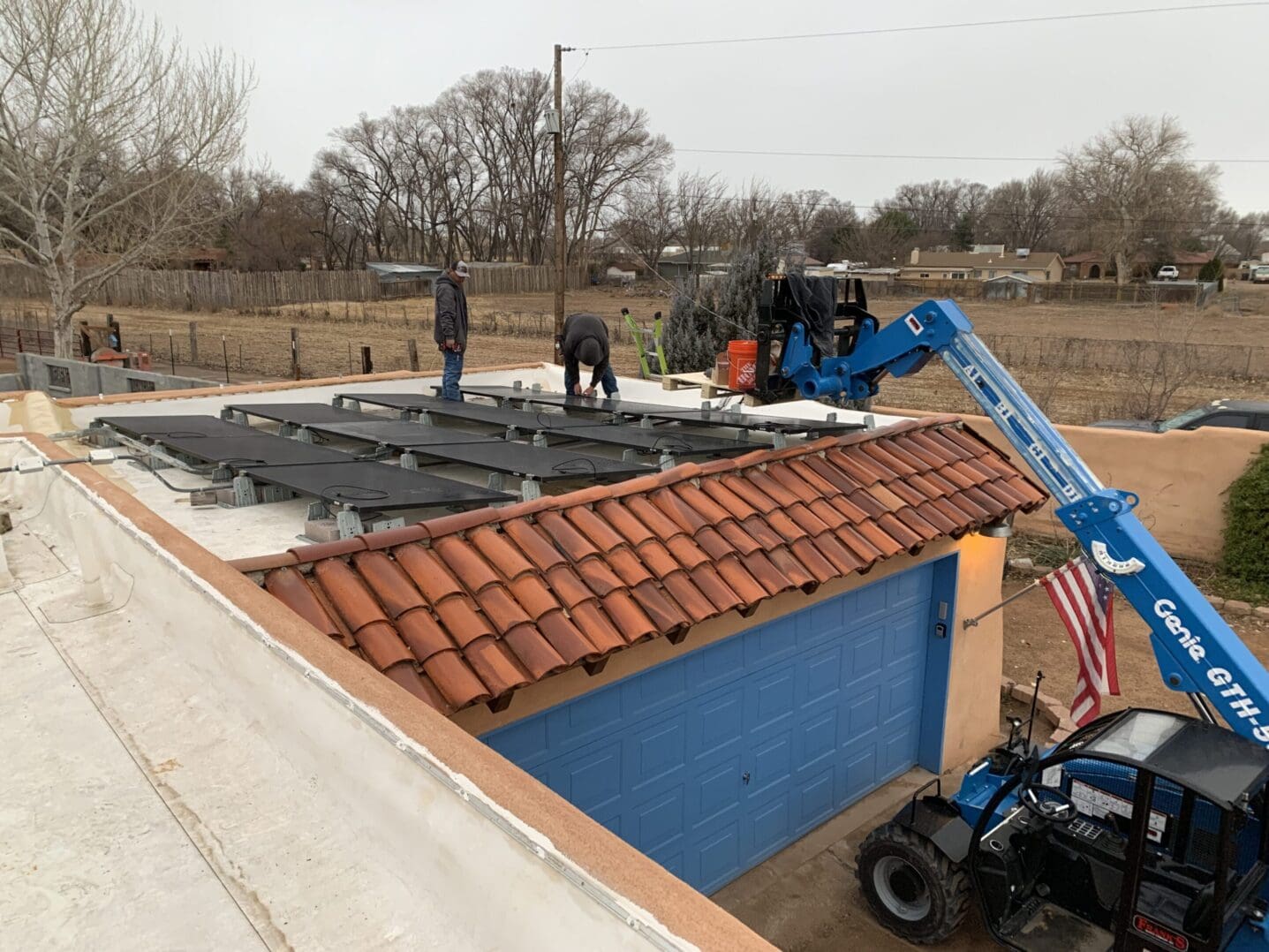 A crane is lifting the roof of a building.