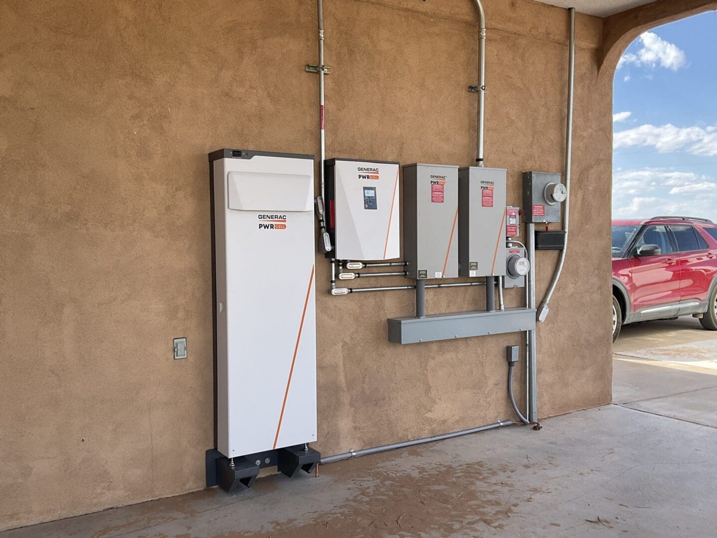 A group of electrical boxes on the side of a building.